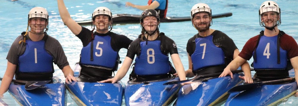 Four students sat in canoes