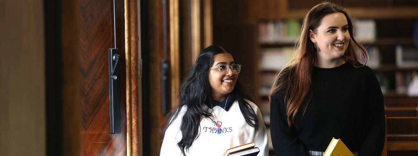 students walking through the library