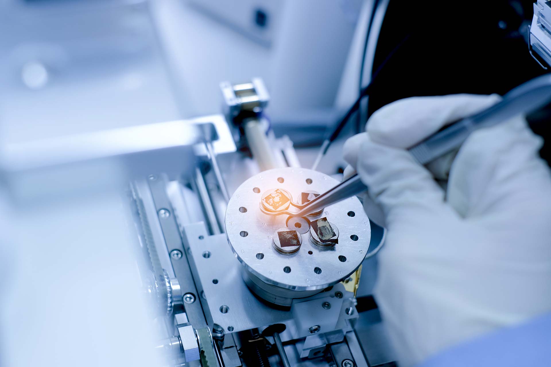 A scientist prepares nanomaterials for a Scanning Electron Microscope (SEM) machine in a laboratory.