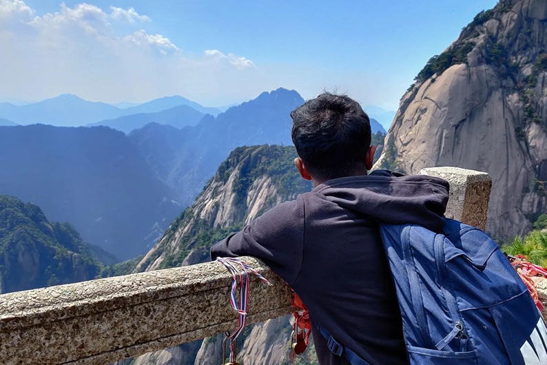 A student admiring a view of mountains