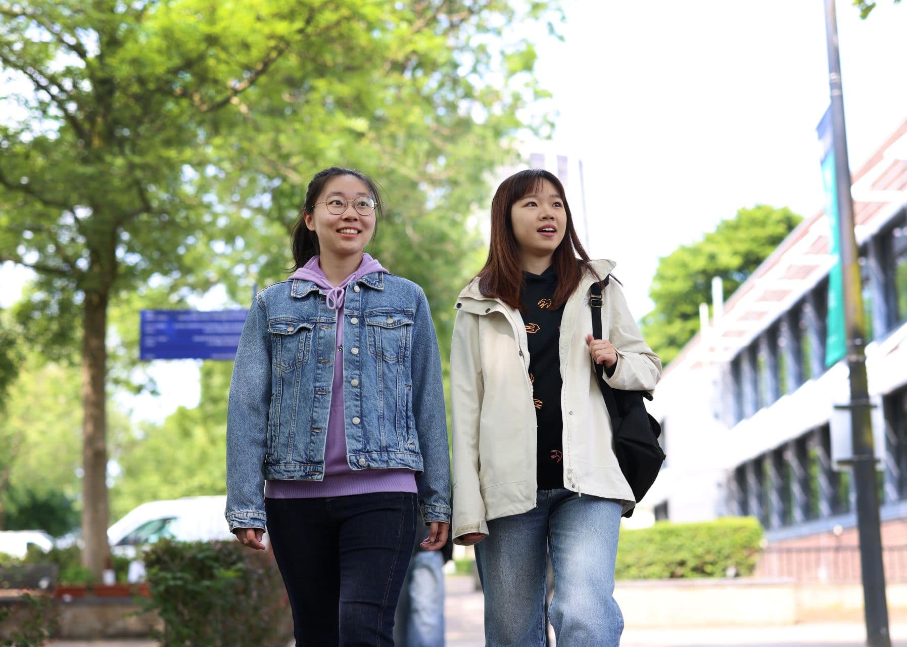 Image of two students walking on campus