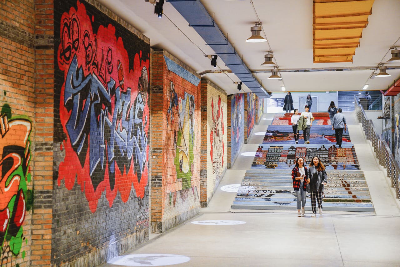 Students walking down a tunnel at the XJTLU campus