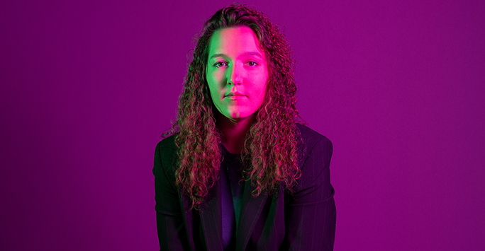 Colourful photograph portrait of a student against a purple background