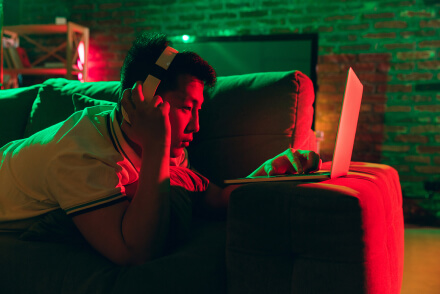 Student studying in room with red and green light
