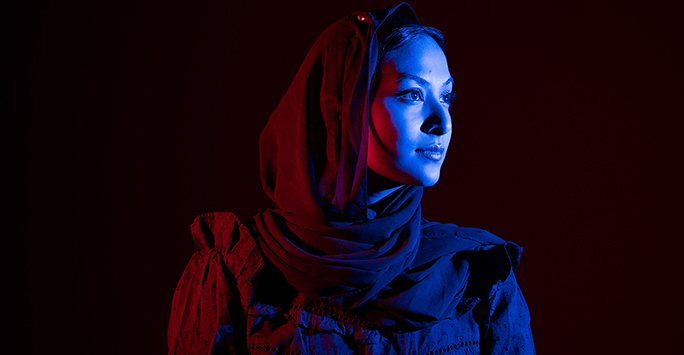 Colourful photograph portrait of a student against a dark background