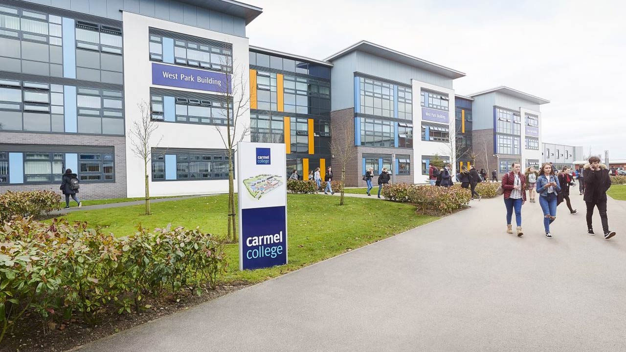 An image on Carmel College and students walking about.
