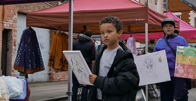 Children selling paintings at Granby Street Market, Liverpool