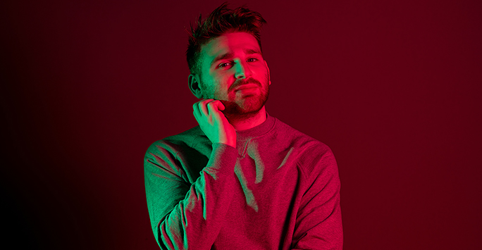 Colourful photograph portrait of a student against a red background