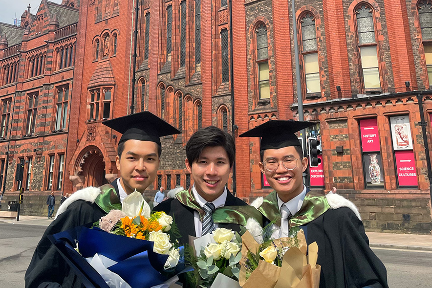 Students with flowers at graduation