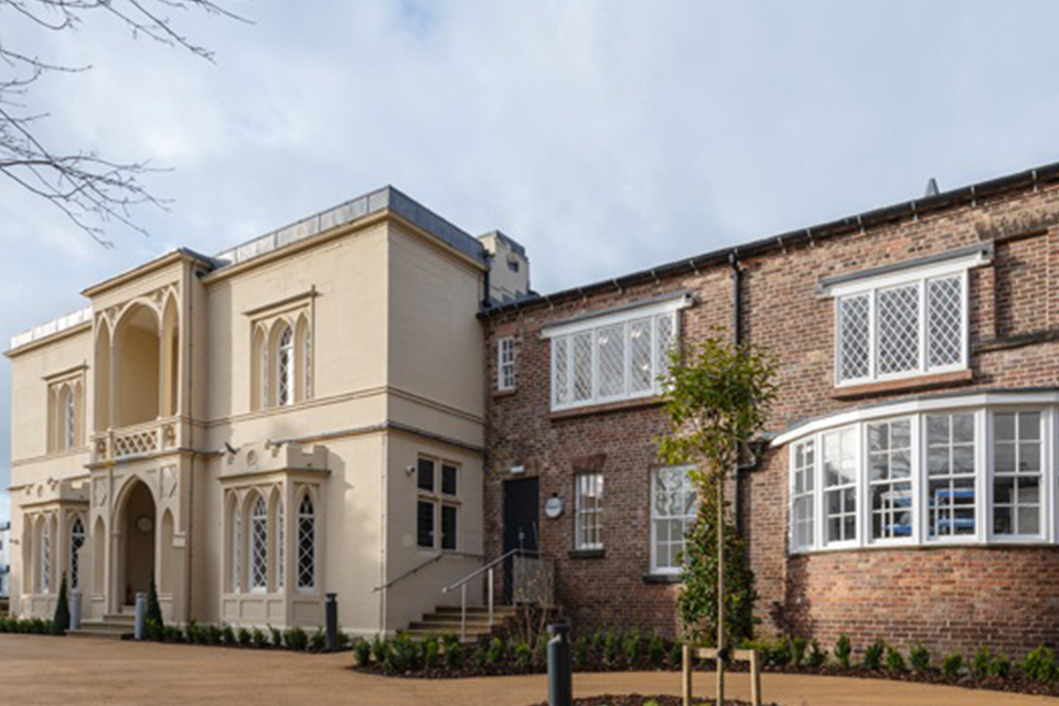 Conference Centre entrance hall with large armchairs and low tables and a staircase