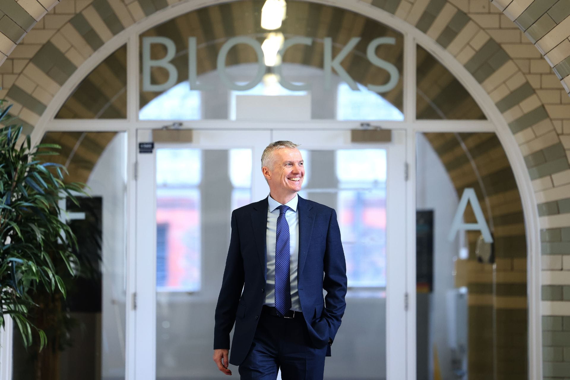 Vice-chancellor walking outside a building