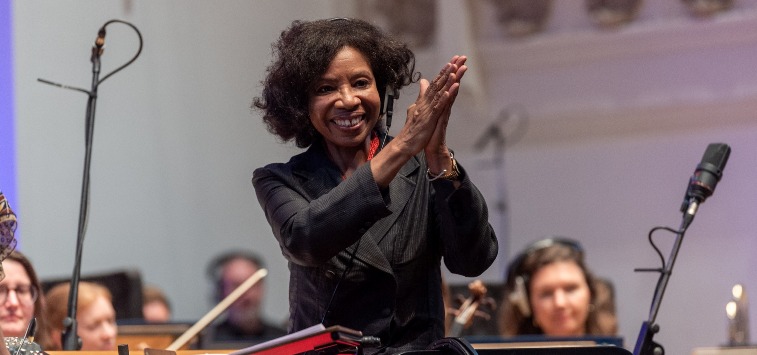 a woman raising hands in thanks