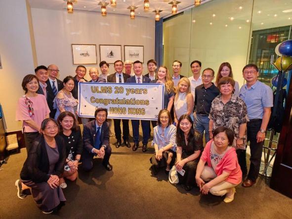 group of people gathered around a banner