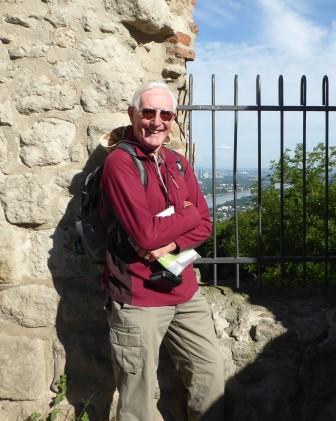 man in red fleece next to iron railing