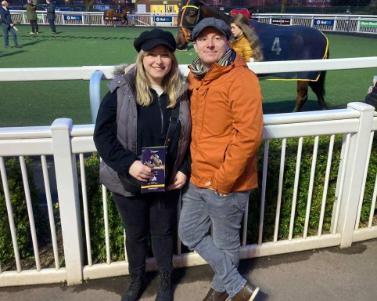 man and woman at race track enclosure