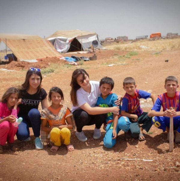 group of adults and children in the desert