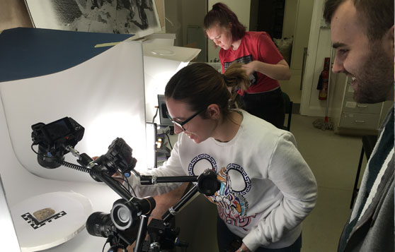 Students taking pictures of ancient artifacts