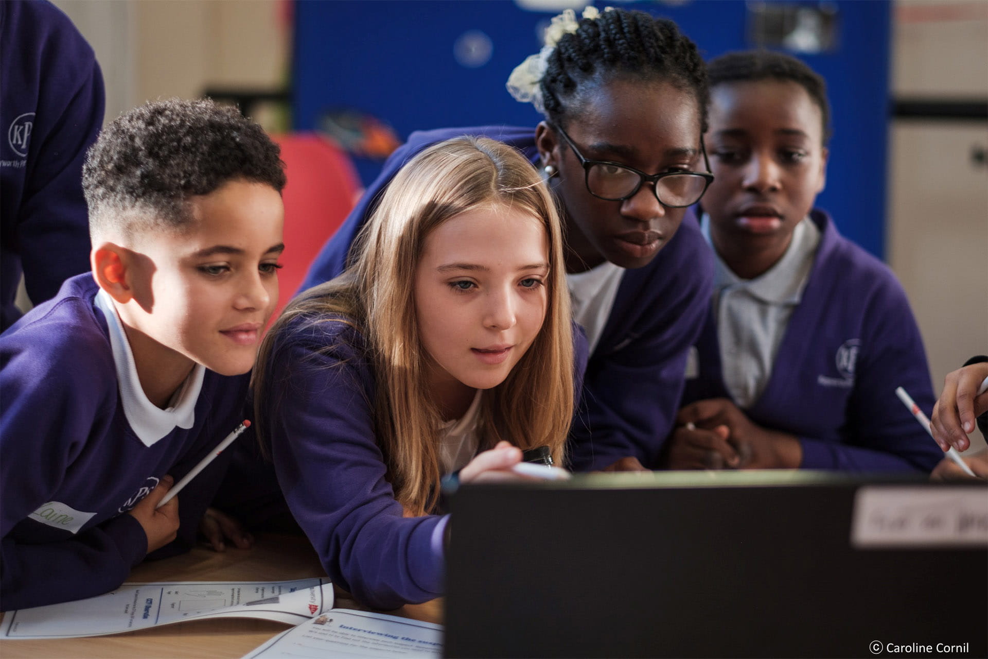 Group of children looking at a laptop screen