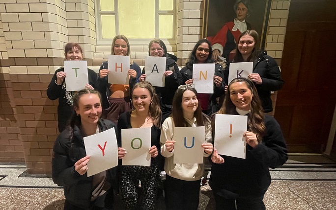 Some of our student callers hold up signs which spell out THANK YOU