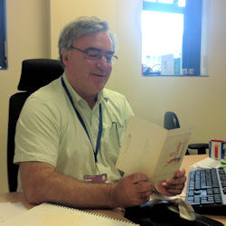 Professor Quinn reading a card from Brenda