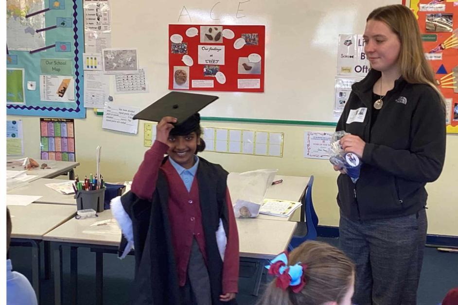 Child with gap and gown and student