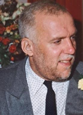 man with beard in profile in shirt and tie