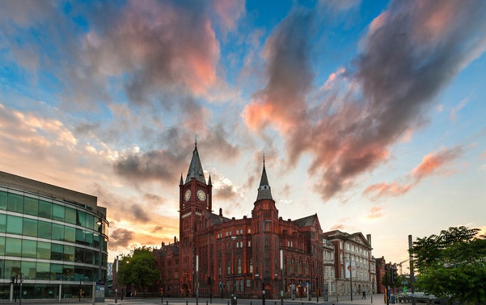 The red brick Victoria Building against a pink and blue sunset