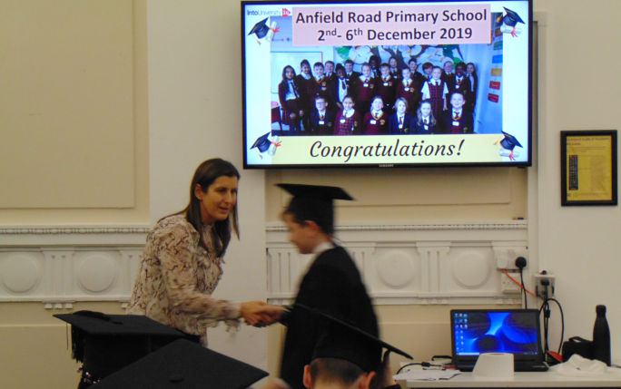 Cath Riseborough awarding IntoUniversity students their graduation certificates