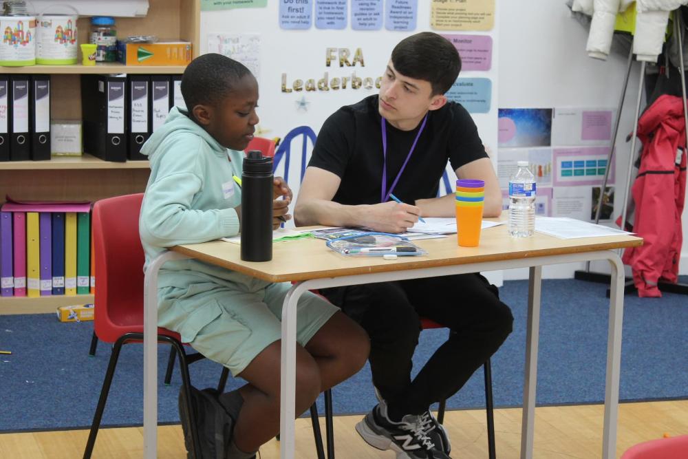 Two people sitting at a desk
