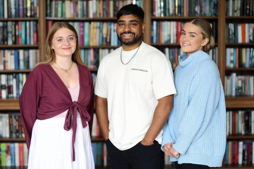 Image of three University of Liverpool students in a library