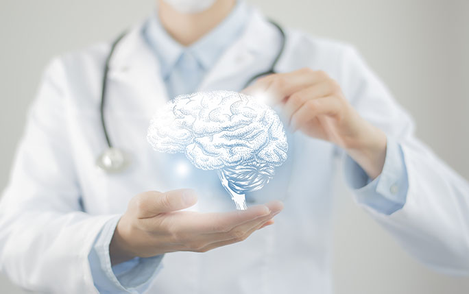 a doctor holding an illustrated brain in palm of hand