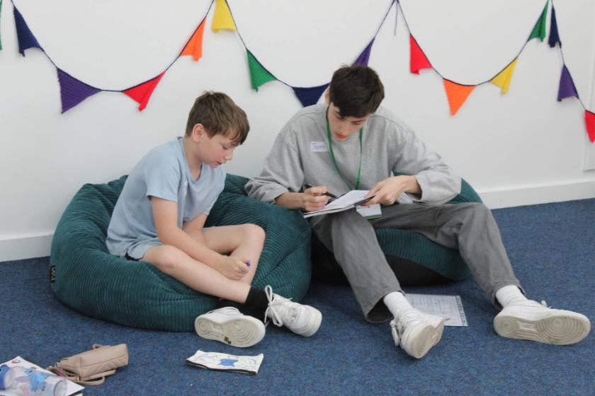 A University student mentoring a primary school student