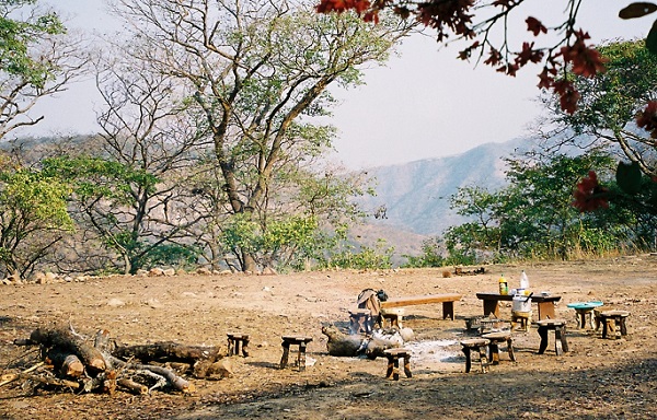 three legged stools create a dining area outside in Kalambo Falls, Zambia