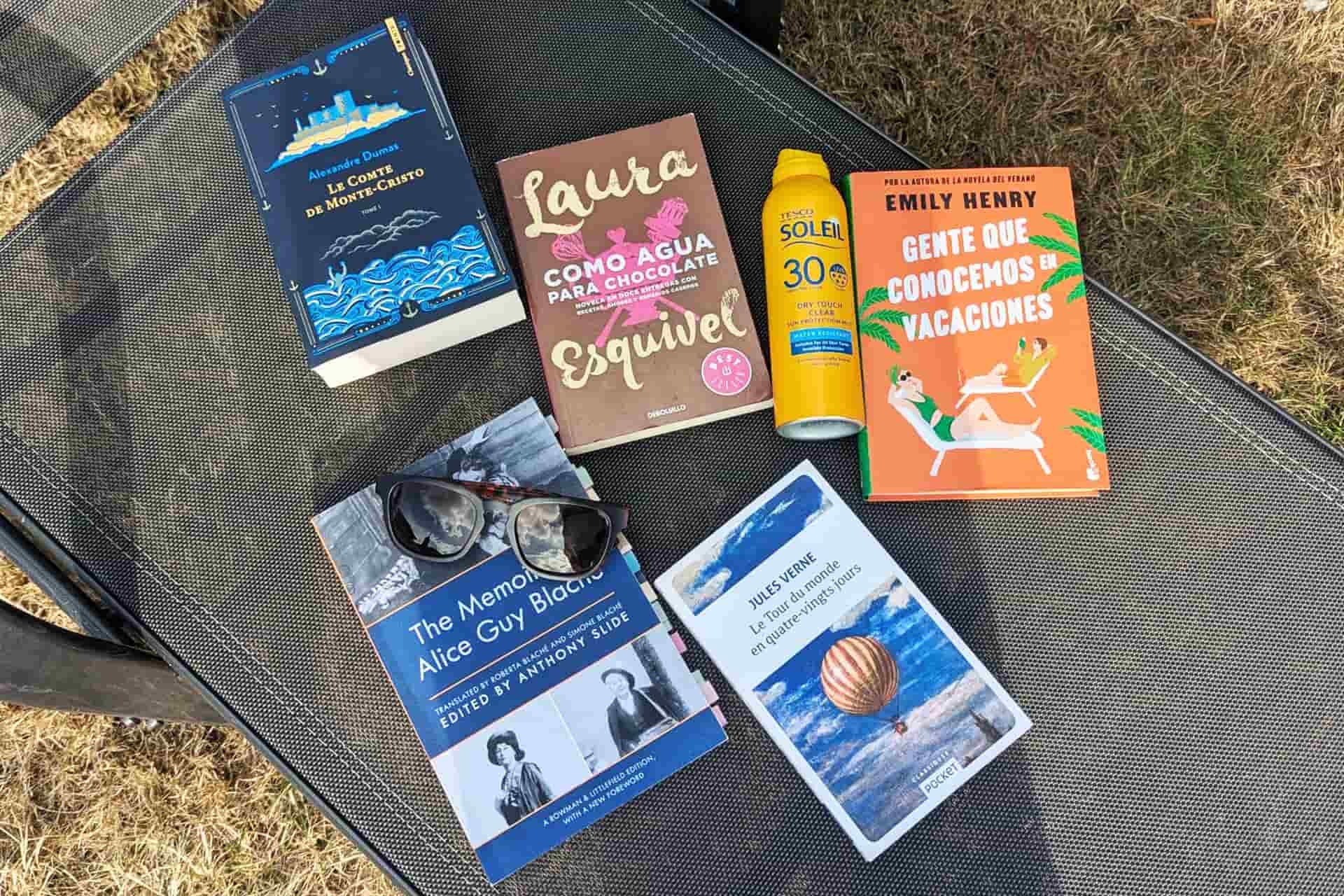 Books on a sunlounger with suncream and sunglasses