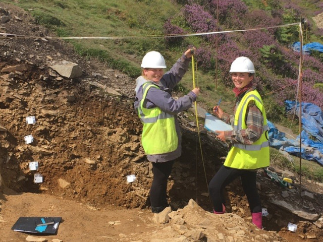 PhD student Elle and recent graduate Emily recording the rampart berm