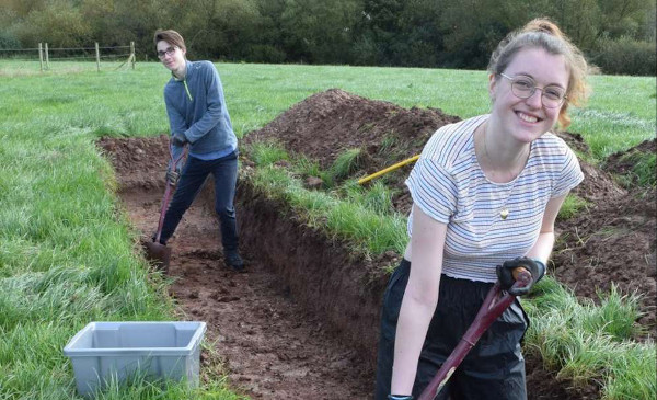 Two students digging