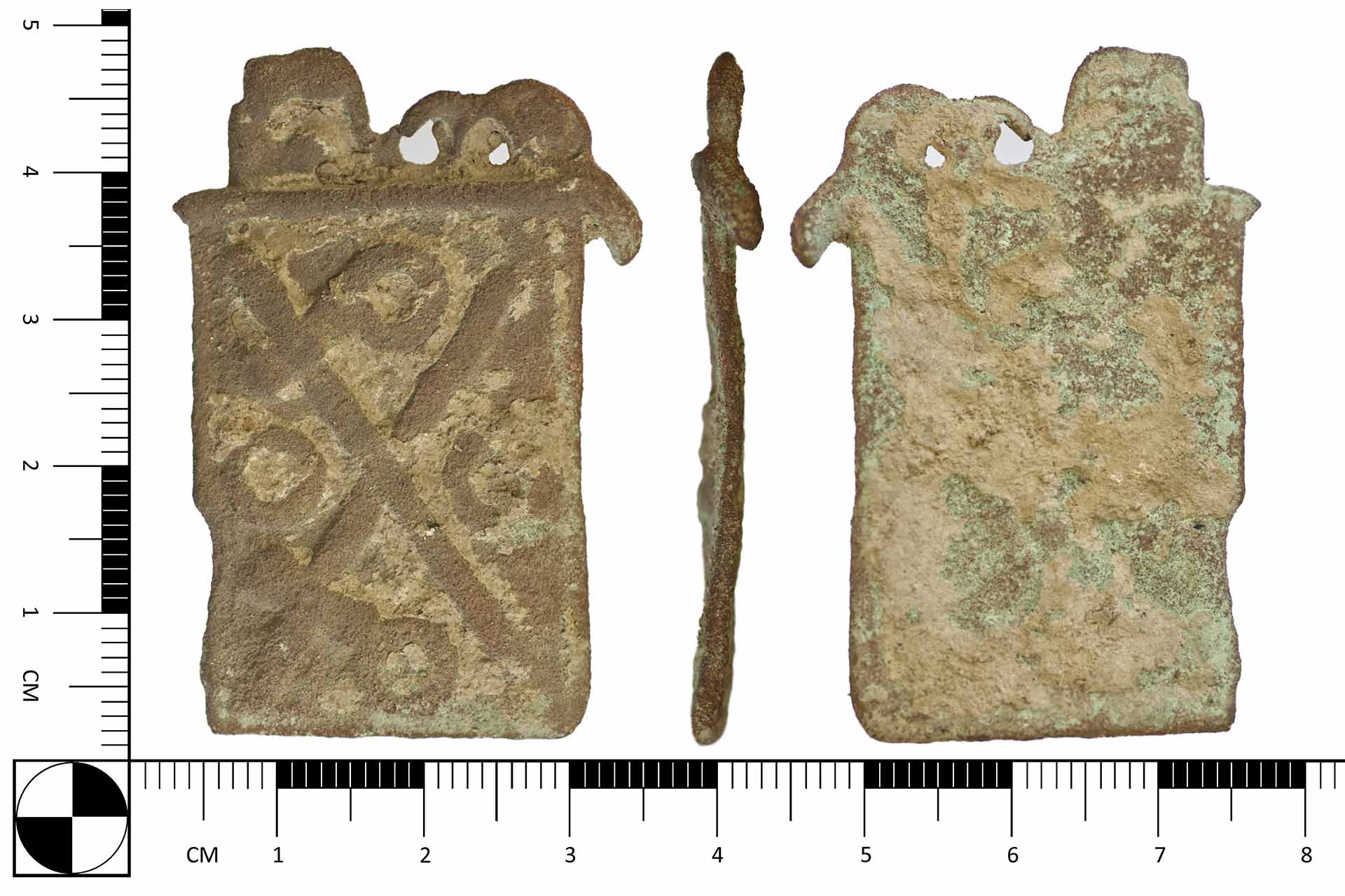 An old belt buckle in front of a ruler showing it to be nearly 5cm tall and 3cm wide.