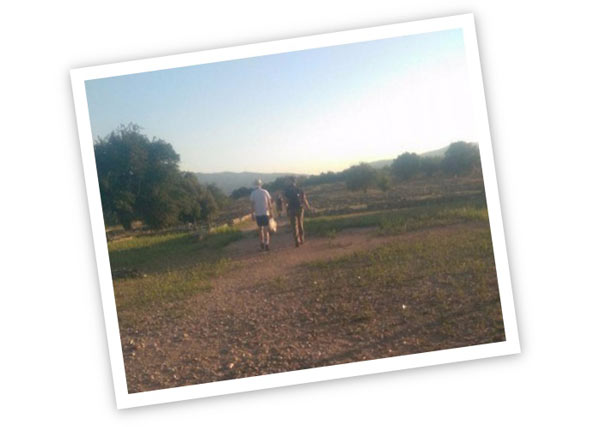 Two people walking through countryside