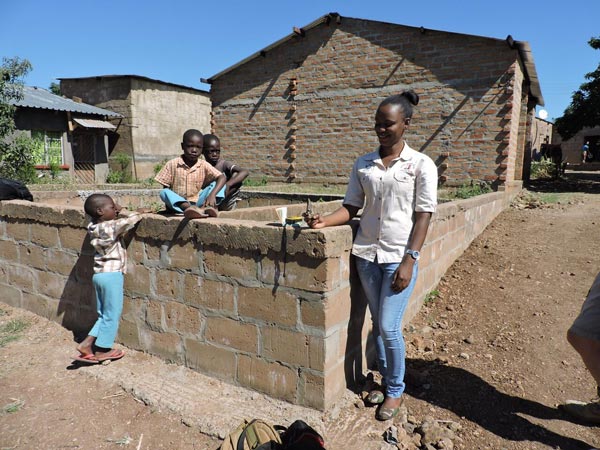 Woman and children at a house in Zambia