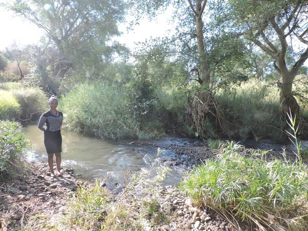 Woman standing by a river