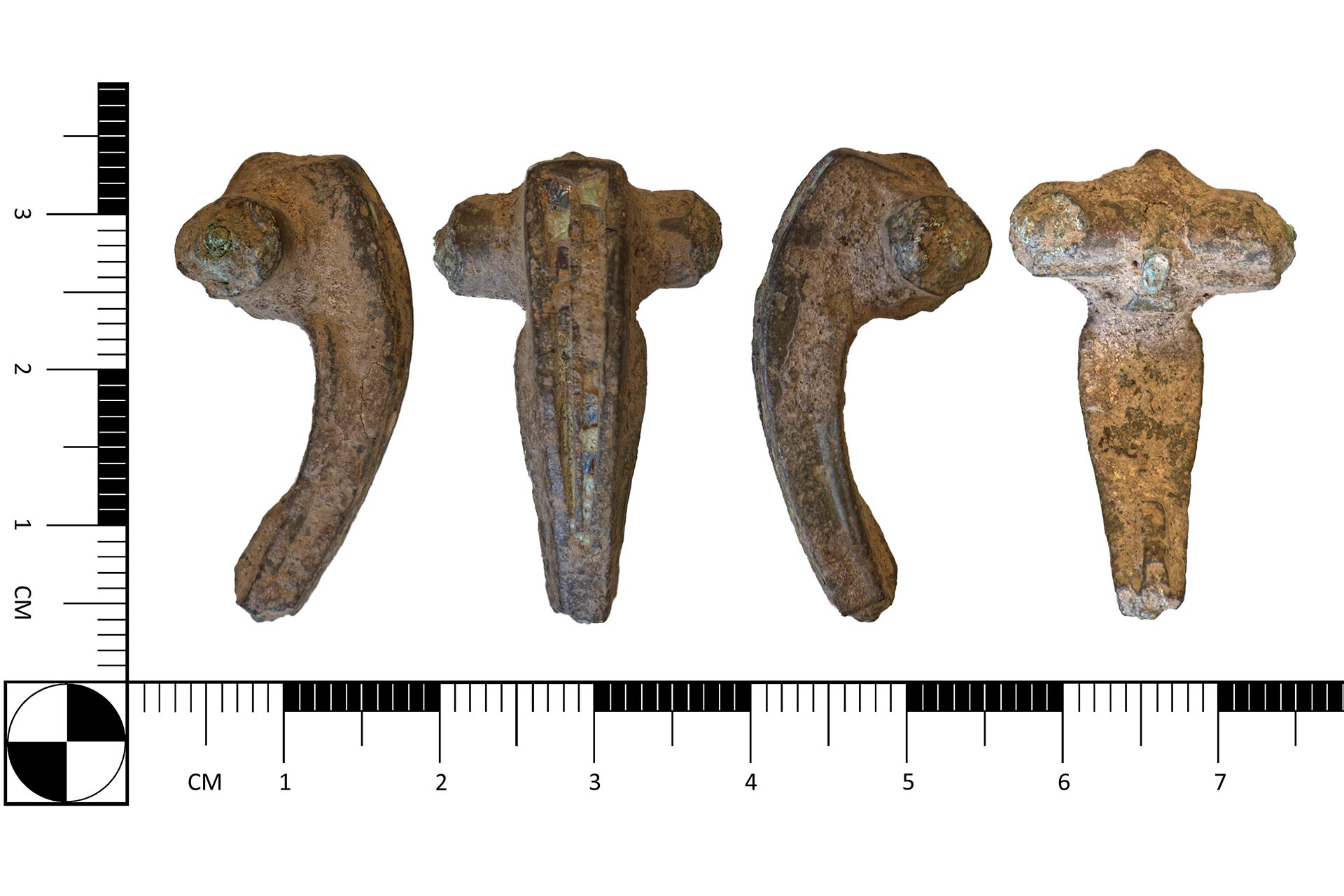 An old brooch  in front of a ruler showing it to be 1.9cm wide and 3.5cm tall.