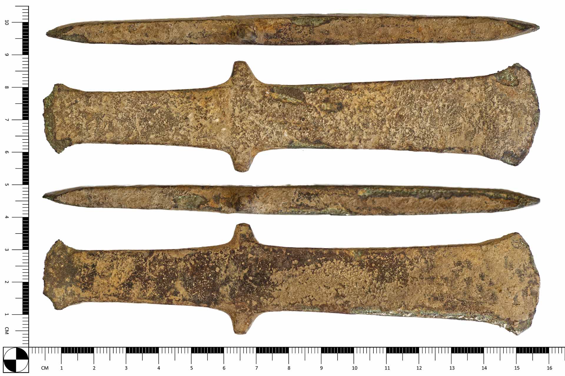 An old axe head  in front of a ruler showing it to be 15.6cm wide and 3.5cm tall.