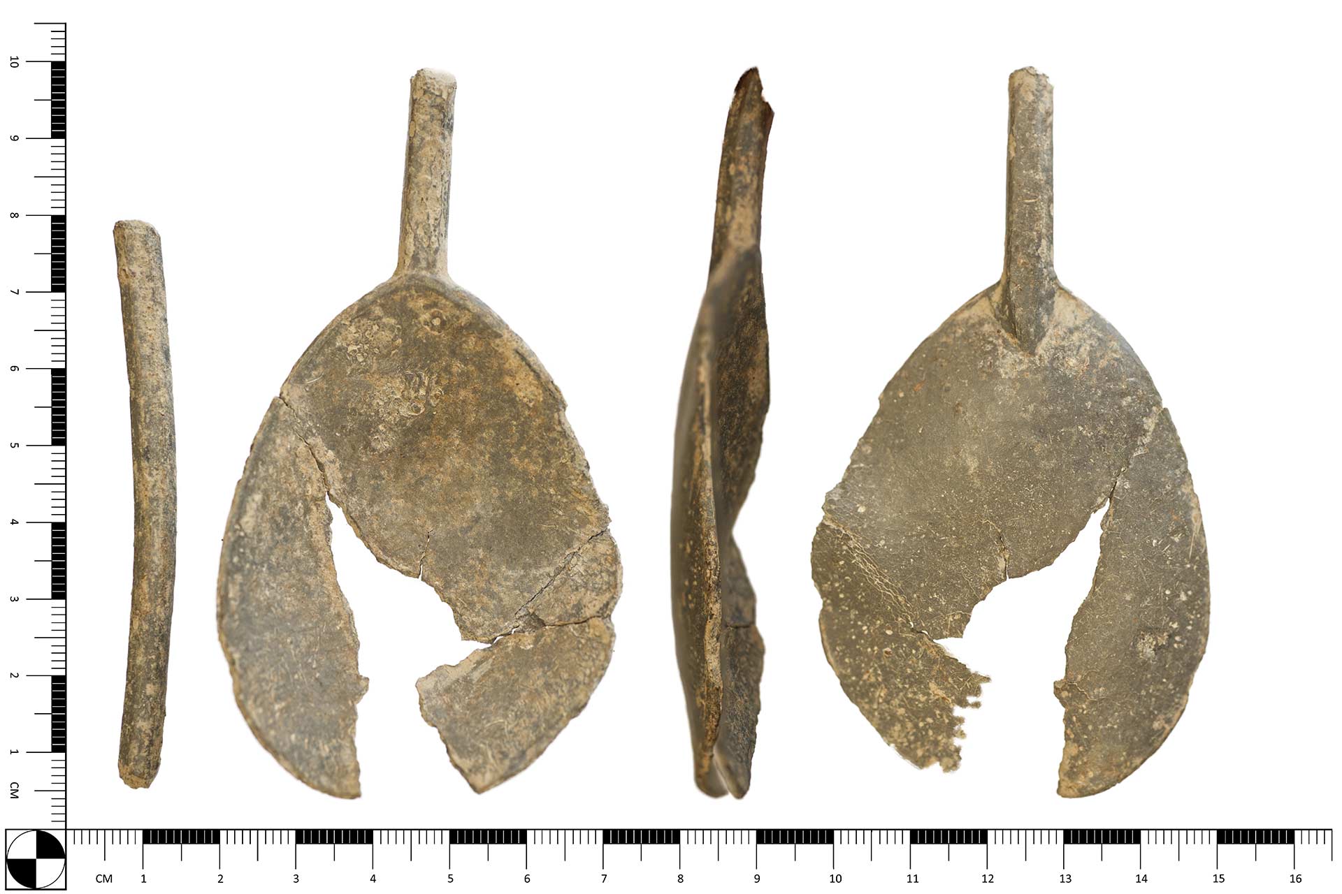 An old piece of spoon  in front of a ruler showing it to be 5cm wide and 10cm tall.