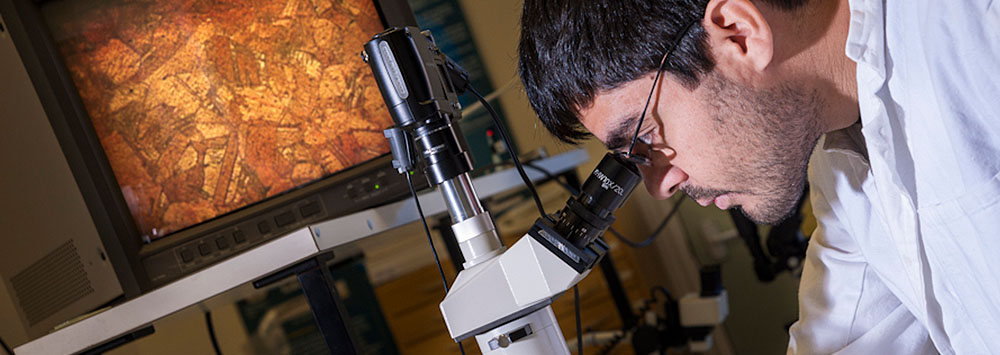 Student looking through microscope