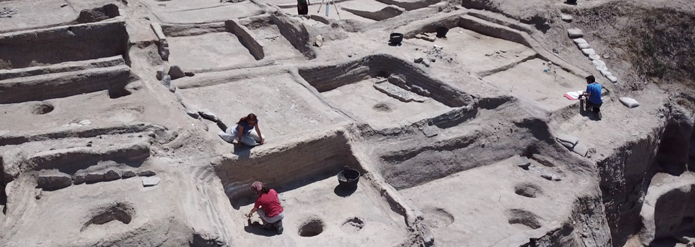 Archaeological site with people excavating the site