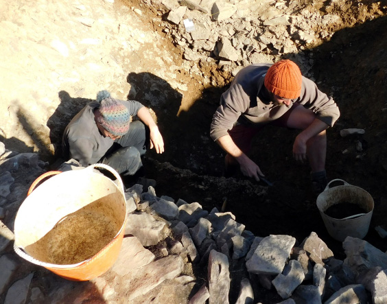 Project directors excavating the rock-cut hillfort ditch