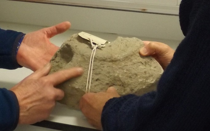 Professor Harold Mytum and John Cruse examine a late-Roman hand quern