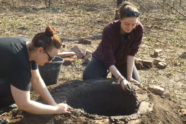 UoL students applying clay render to the kiln