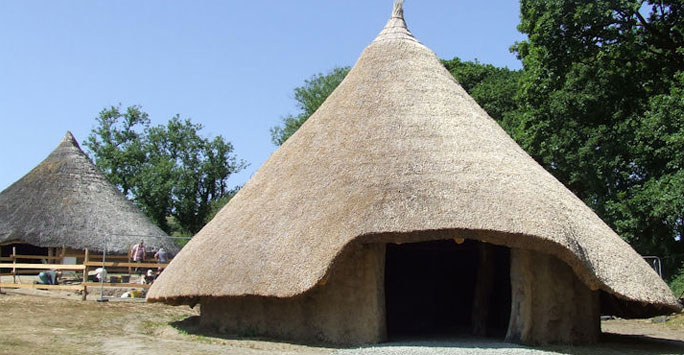 ancient roundhouse made from thatch - part of the Castell Henlys research project