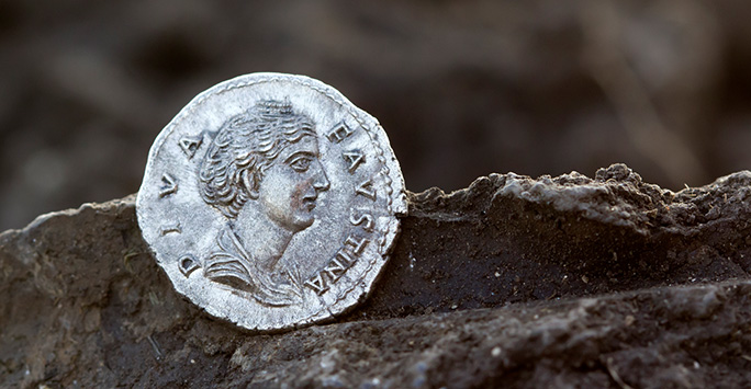 Roman coin covered in dirt